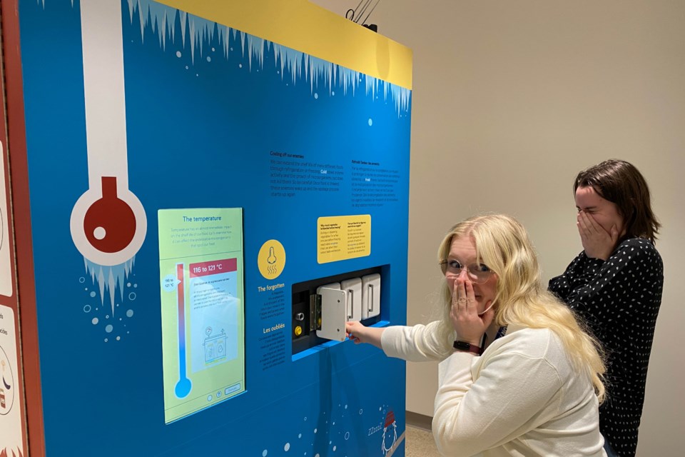 staff-try-out-an-interactive-display-in-a-taste-of-science-that-invites-visitors-to-identify-foods-forgotten-in-the-fridge-by-scent