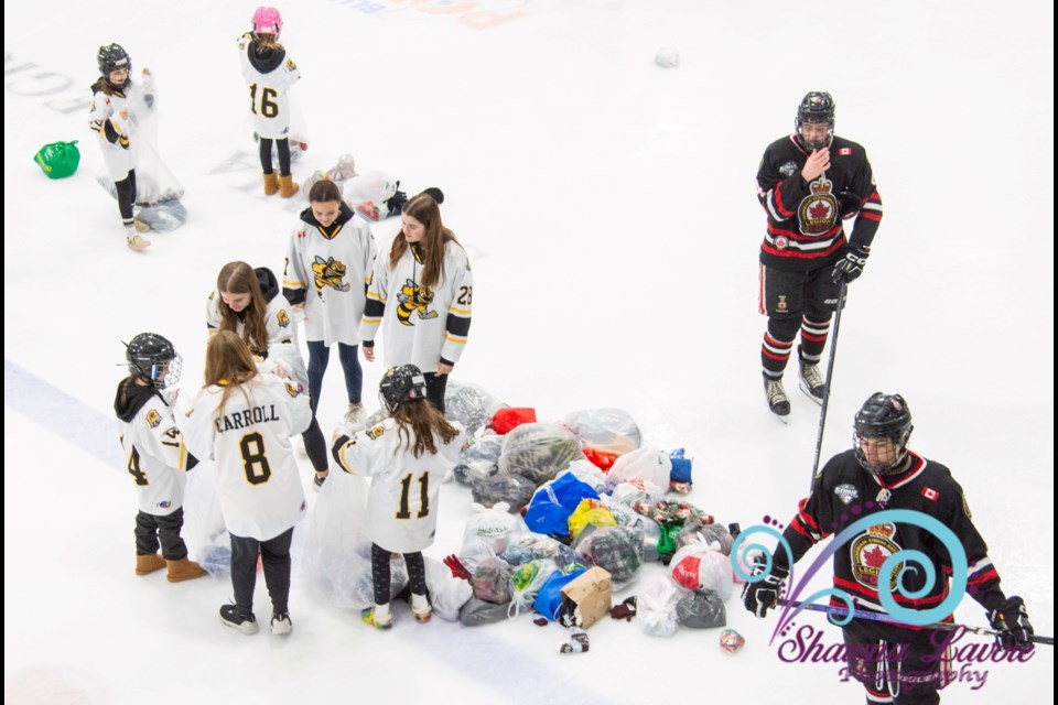 Members of the Sarnia Jr. Lady Sting helped collect donations during the Sarnia Legionnaires' 4th annual Wooly Toss game, Thursday.
