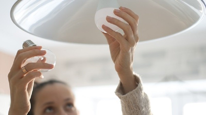 FCC photo – person changing a light bulb