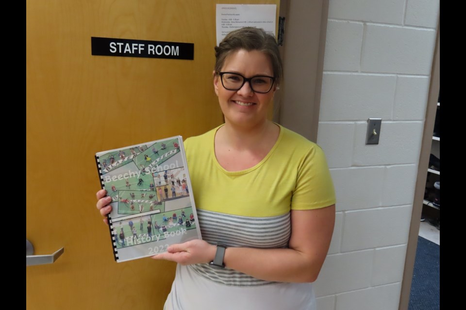 Teacher Brianne Denning holds a copy of the new Beechy School History Book. Photo by Derek Ruttle/The Outlook.