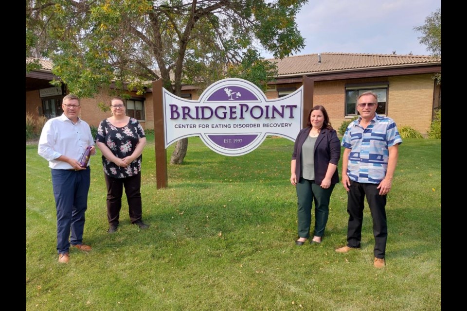 Premier Scott Moe, program director Lauralyn Blackburn, executive director Carla Chabot, and MLA Jim Reiter outside the center in Milden. Photo by Derek Ruttle.
