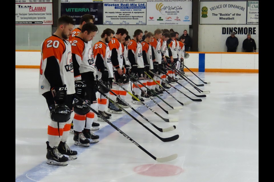 The team bows their head in a moment of remembrance before the game.