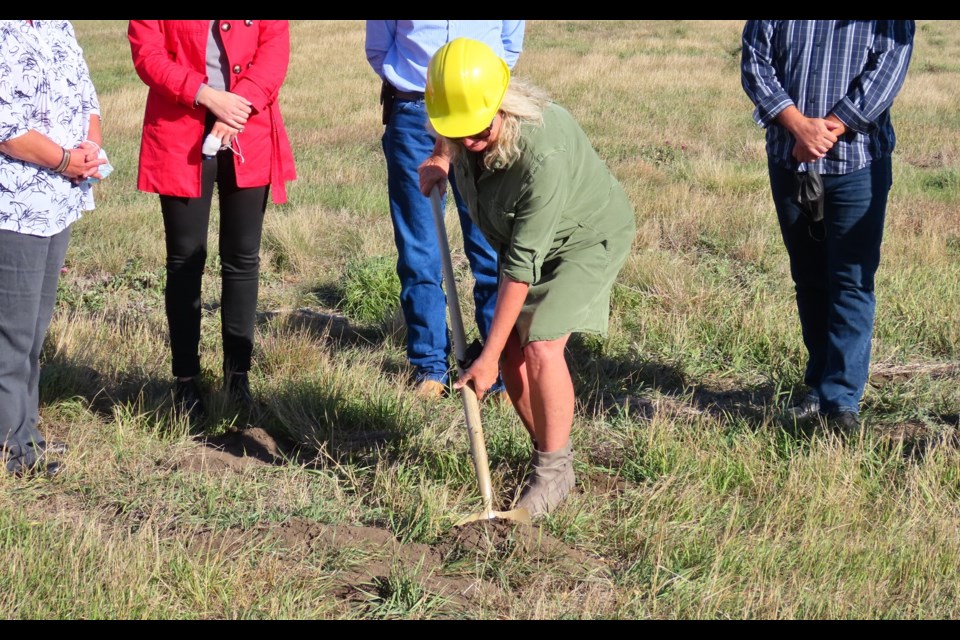 Village of Elbow Mayor Colleen Hoppenreys makes it official by turning the sod.