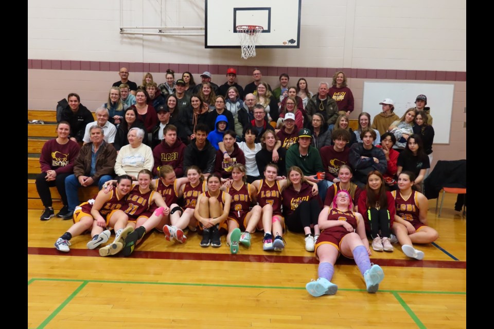 The Lady Bisons team gathered with family, friends and supporters for a big group shot to conclude the tournament.