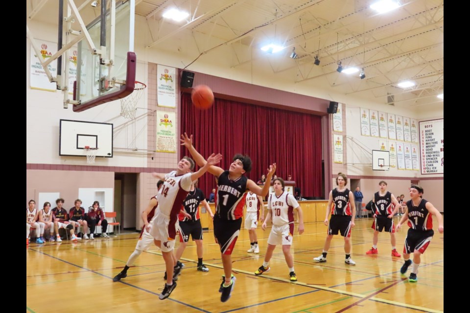 Bisons #14 Kalen Follick and Herbert #1 Ronan Haughian reach for the skyward ball in the game that would decide who would head to the tournament final. Photo: Derek Ruttle/The Outlook