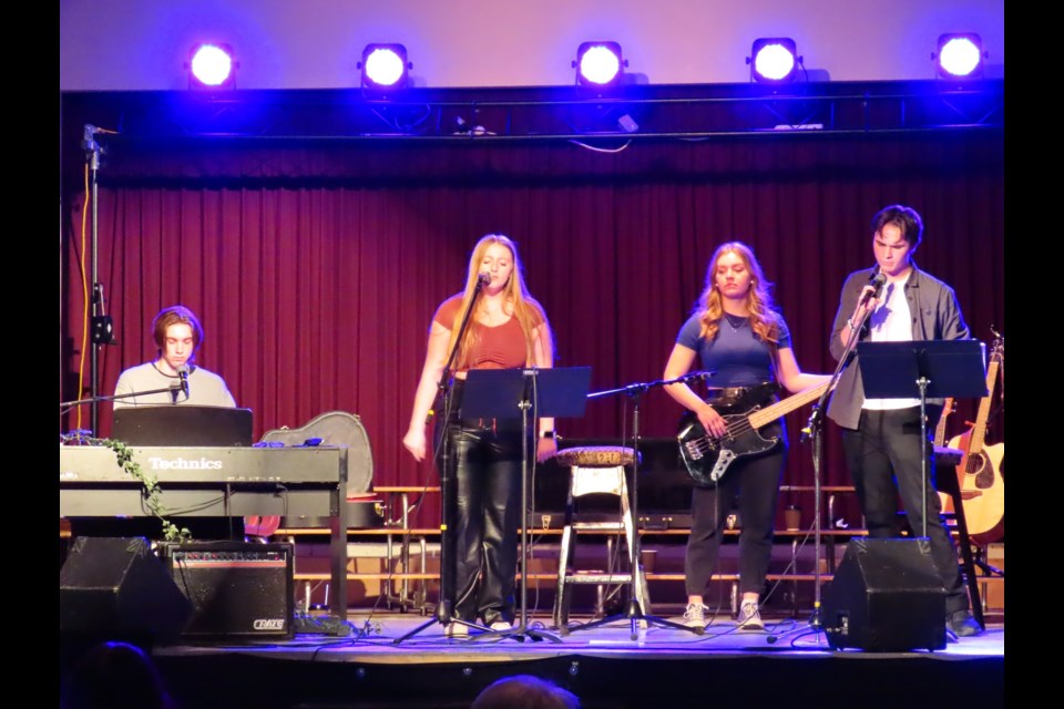 Liam Jones, Jenna Fleck, Asta Hovdestad, and Trason Ridgewell performing onstage.