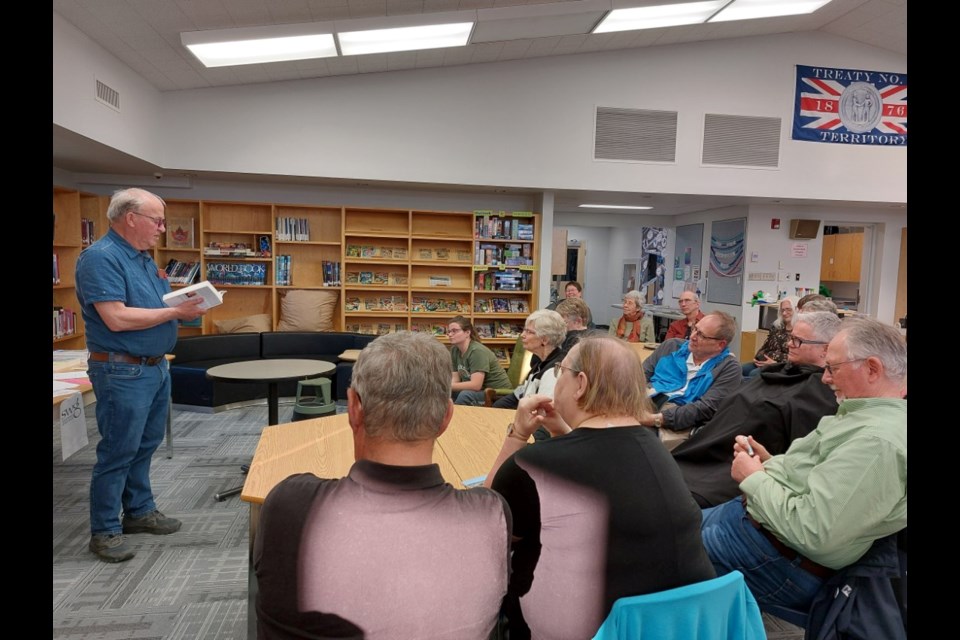 Tony Peter reads to the audience. Photo by Derek Ruttle.