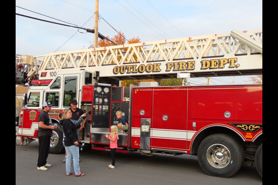 People enjoyed checking out the trucks and equipment outside on the street.