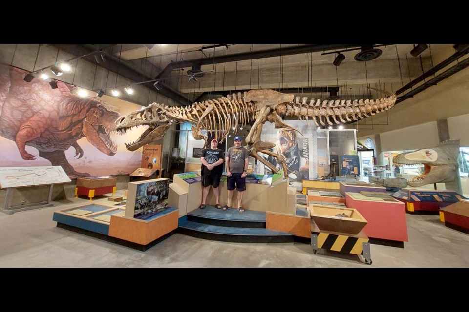 Derek and Brendon Ruttle pose with 'Scotty', the Tyrannosaurus Rex skeleton mascot of the T.Rex Discovery Centre in Eastend. Photo by Derek Ruttle.
