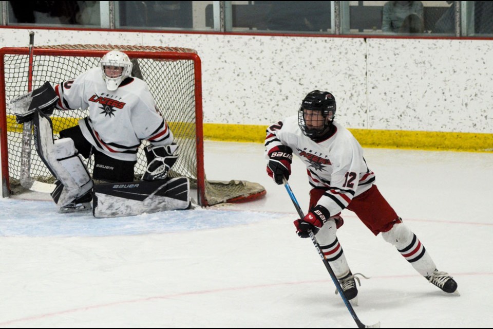 Lazers’ provincial team captain Dawson Rusk uses the boards to catch his balance after shooting the puck. Also in the photo is teammate Brandt Gilbert.