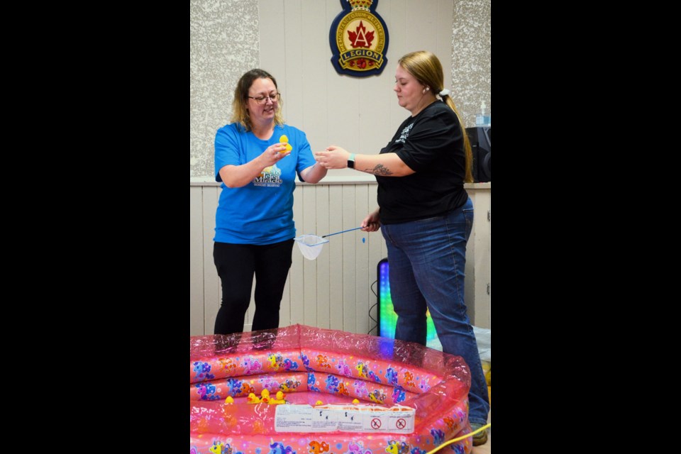 Unity Kin Club President, Nora Aldred and Duck Derby chairperson, Breanna Elder, select ducks in the elimination style event.
