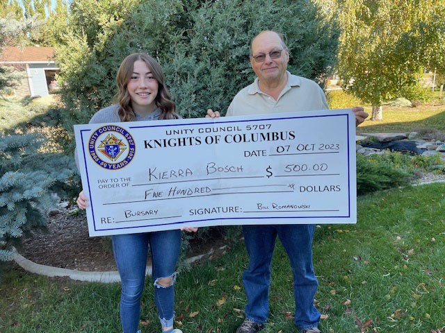 Kierra Bosch receives a $500 bursary from K of C treasurer Gerald Beres.