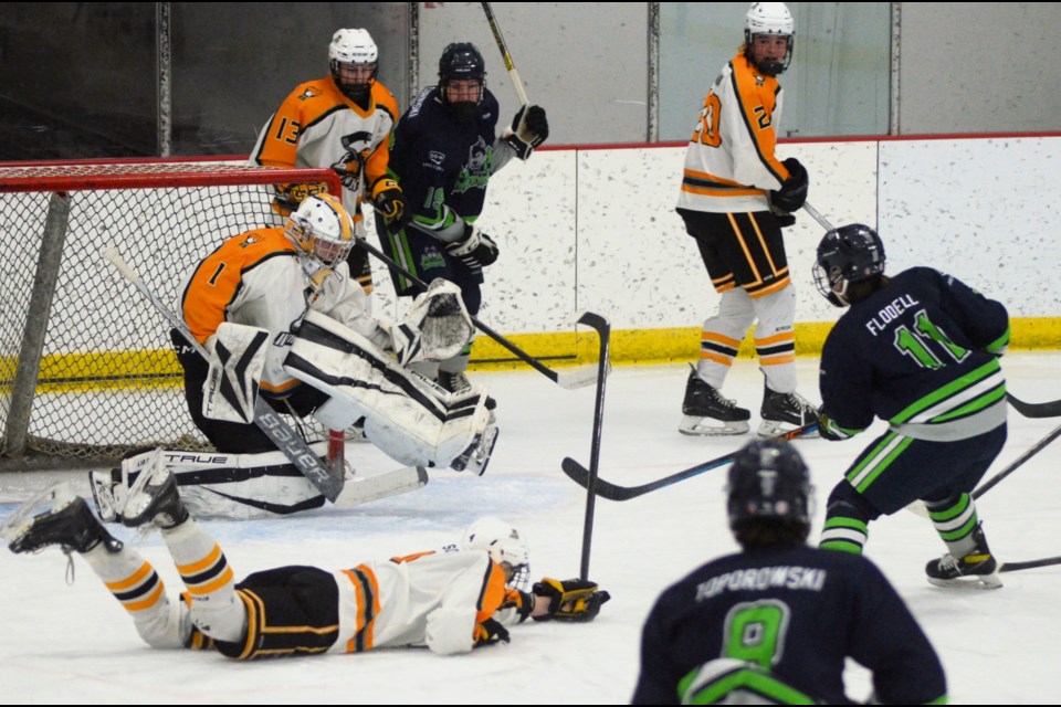 Wheat Kings goalie Jaden Blanchette uses his legs to make the save after the shot gets past teammate Graydan Ewson. In the background are Emerson Cey and Deegan German. Prince Albert Lake Country players are Dylon Clarke, Cohen Toporowski and Ty Flodell. 