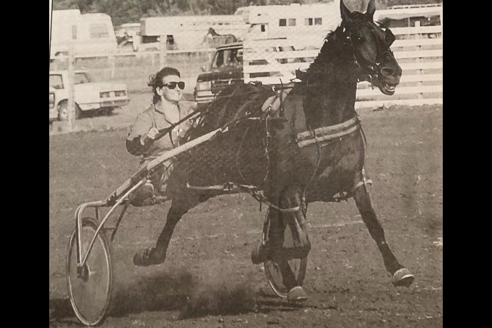 Lorna Kuntz heads down the stretch in a sulky race held after the 1995 rodeo.