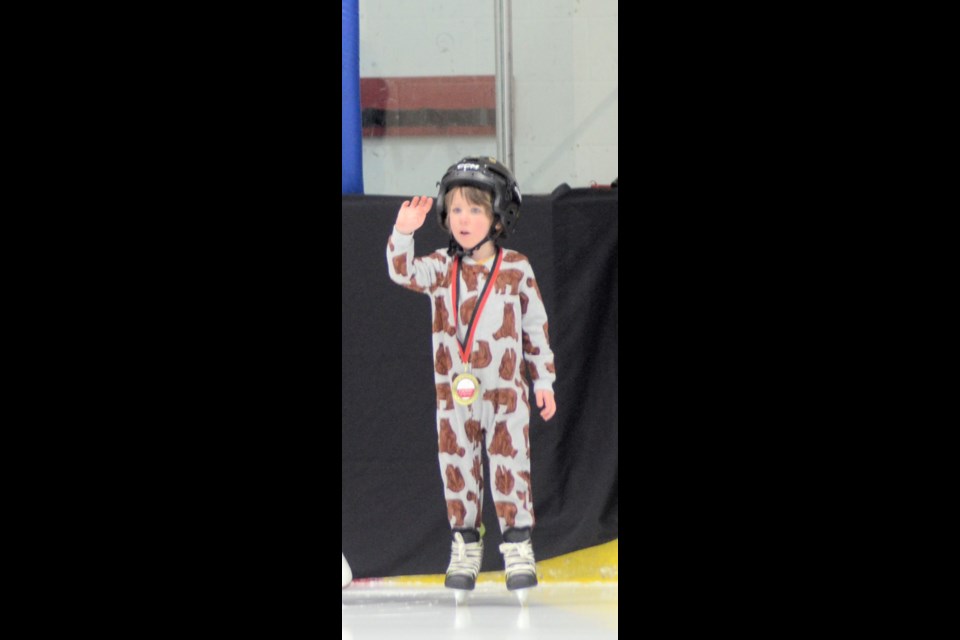 Asher Kreimeier waves to the audience after receiving his CanSkate award.