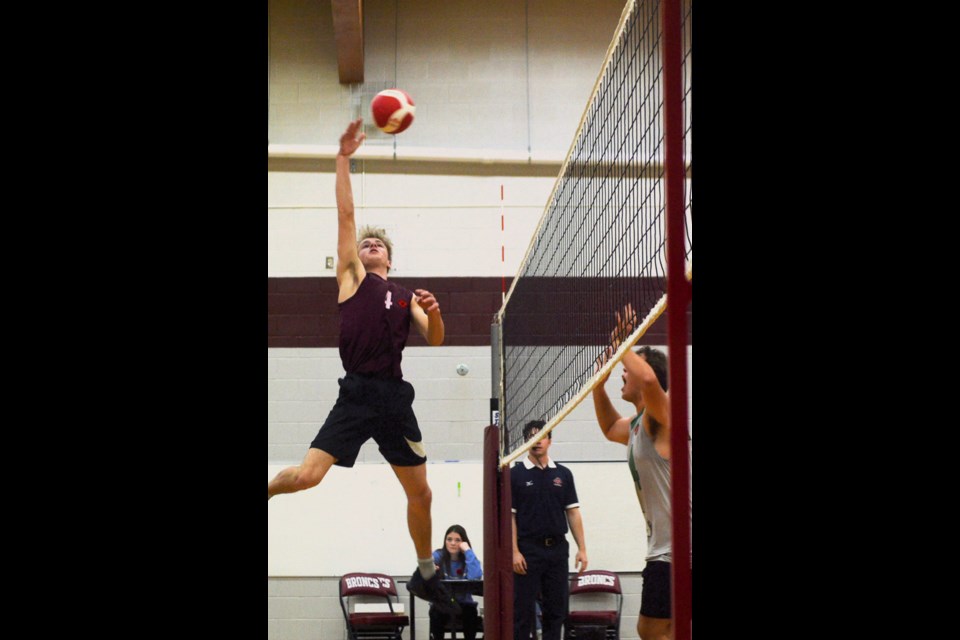 Reece Harris gets some height to “spike” the ball in McLurg’s conference volleyball game against Lashburn, Nov. 11.