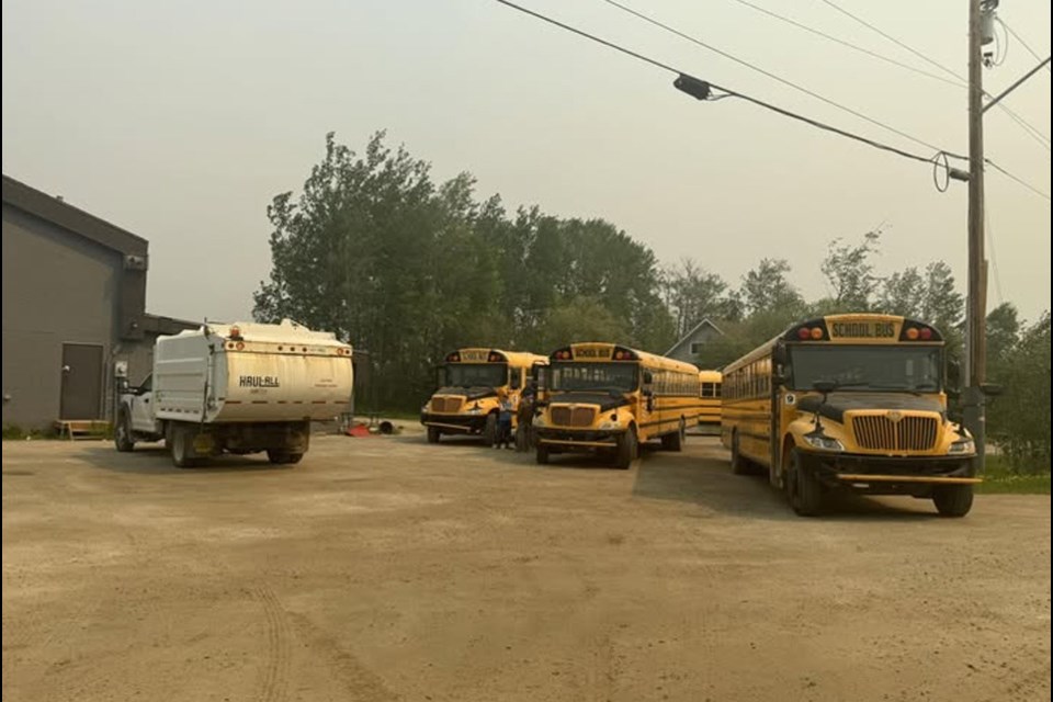 Buses at the Sucker River Band Hall preparing to move evacuees.