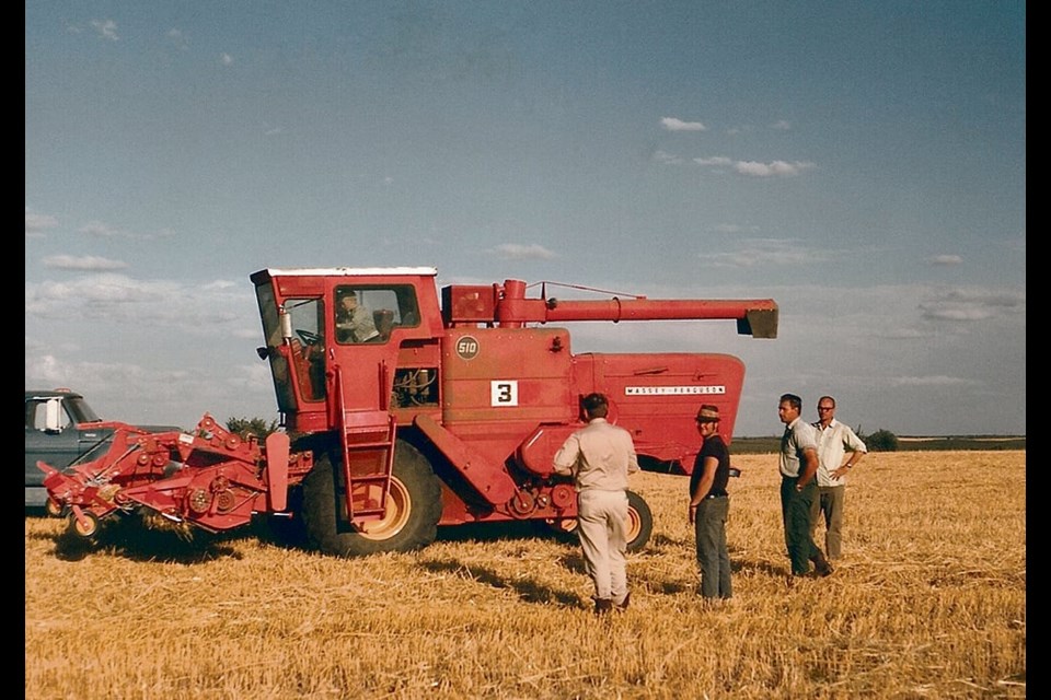 Engineers working on field trials with a 510 combine, circa 1960s. 