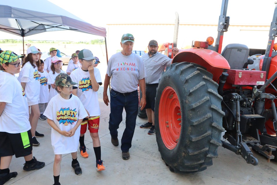 Roger Clay points out danger zones of a tractor during the Ag Safety Day.