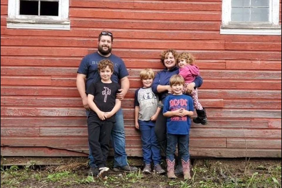 The Bullock Family enjoys dirt biking, horseback riding, and building forts – in addition to pitching in to help with gardening, animals, and the homesteading lifestyle. Pictured in front the nostalgic old barn in the summer of 2021, were, from left: Colin (dad) and Benjamin, Lukas, Franky (mom), Joseph, and Lily.