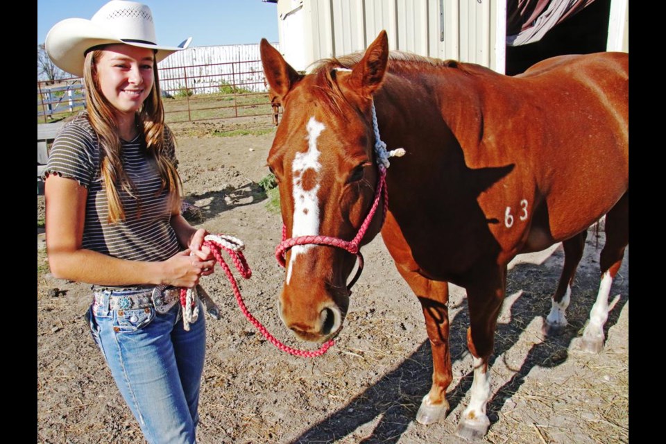 Charlize Hallberg posed with her horse Baby, housed on her grandparents farm just east of Weyburn.