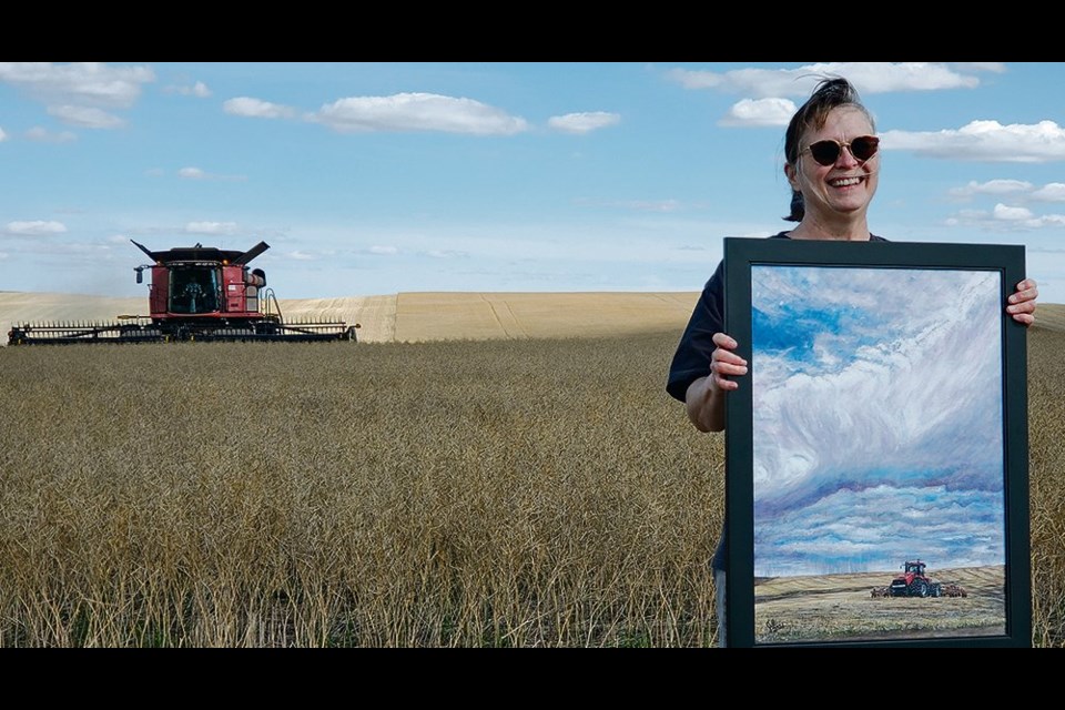 Jill Mitchell, a project ambassador with Grow Hope Saskatchewan, holds the painting, “Feeding the World — One Grain at a Time” that was auctioned off during harvest at the charity’s project near Bruno, Sask.