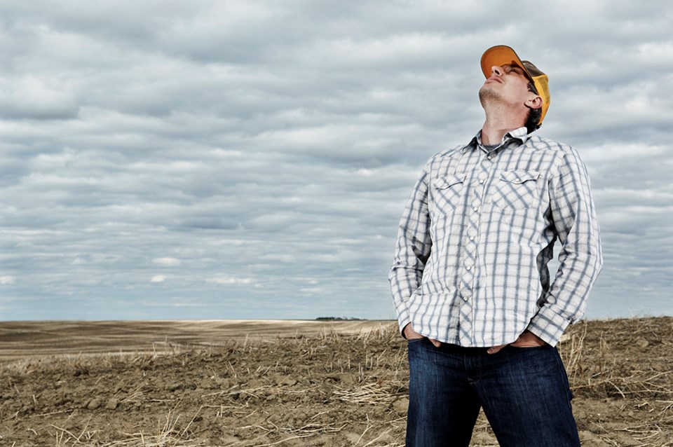 man looking for rain in field