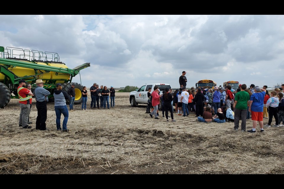 North West Terminal's Dan Feser talks to students about the day's activity with the Farming for the Future field day demo and seeding operation.