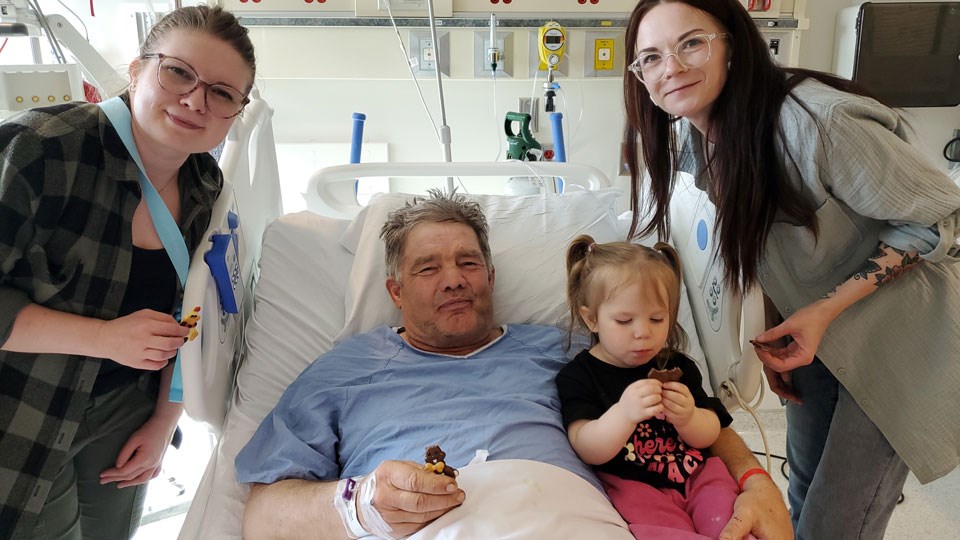 Carl Lang, celebrating Easter at the Regina General Hospital, with, from left, his daughter Kaitlin, granddaughter Vivian and daughter Victoria. 
