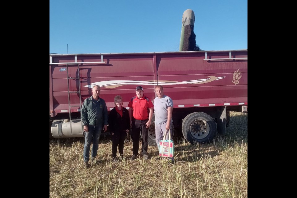 As part of Rama Co-op’s Harvest Bags program, special cooler bags designed by FCL are filled with Co-op snacks and beverages, and delivered to local farmers to brighten up their day while they’re putting in long hours during harvest. In this photo, Glenda Jeffrey, agro manager and Logan Schultz, assistant agro manager, made the presentation to Avery and Trent Kresak while their truck filled with canola. From left, were: Avery Kresak, Glenda Jeffrey, Logan Schultz and Trent Kresak.