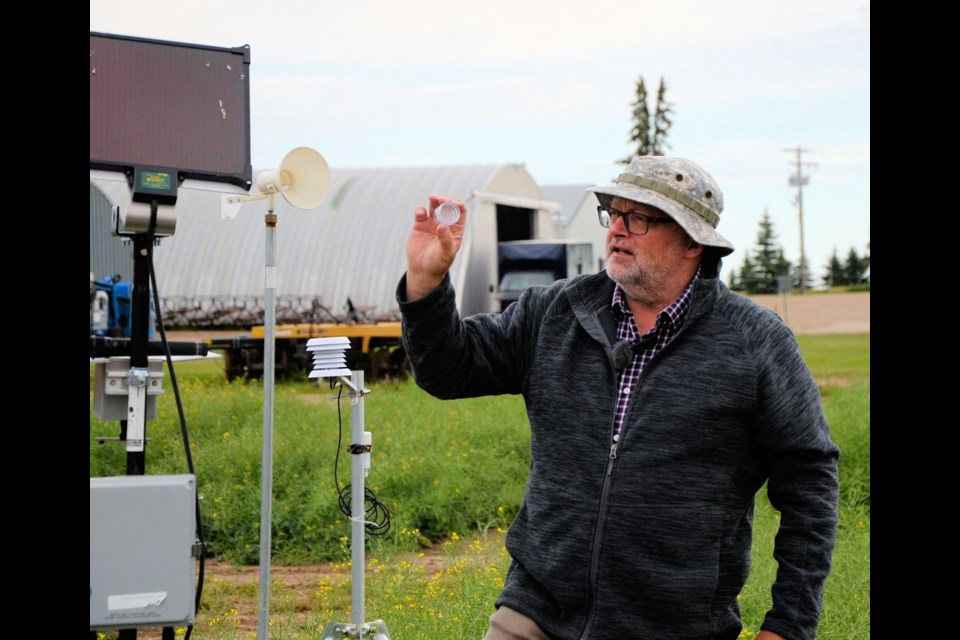 Dr. Kelly Turkington, an AAFC research scientist, explains a cartridge which collects sclerotinia spores in the air to help farmers make a timely decision on whether or not to apply fungicide in their canola fields.