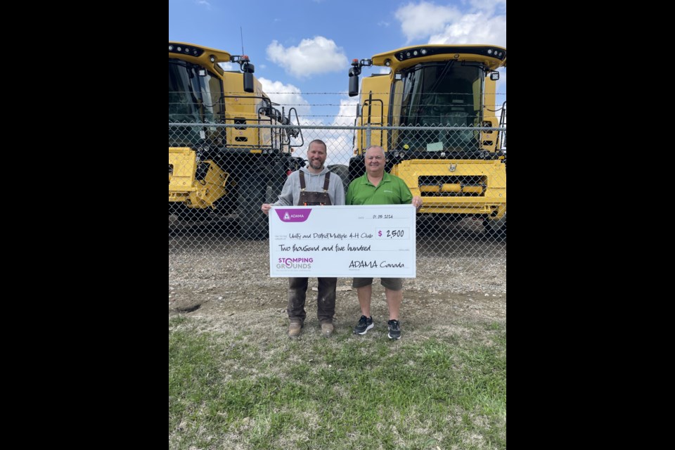 Jarrett Lewin, co-general leader for the Unity & District Multiple 4-H Club, accepts a $2,500 donation from Gord Hounjet, Area Business Manager for ADAMA Canada. 