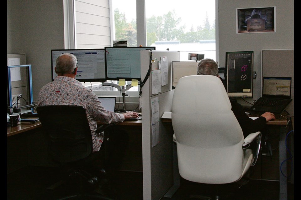 Teachers at work in the Sask DLC head office in Kenaston, Sask.