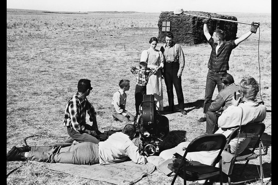 A film crew shoots a scene with the actors playing the pioneer Greer family in Drylanders. The sod house in the background was built for the film on the Thierman farm near Webb, Sask. 