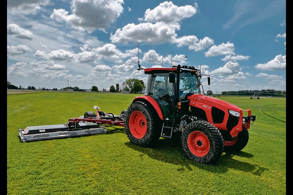 
A Kubota M5 tractor equipped with the Sabanto autonomy system mows on a sod farm. 
