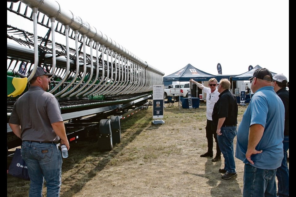 Zac Corbin of S3 AWS Airbar explains features of the FDX model to farmers at Ag in Motion in July. | 
