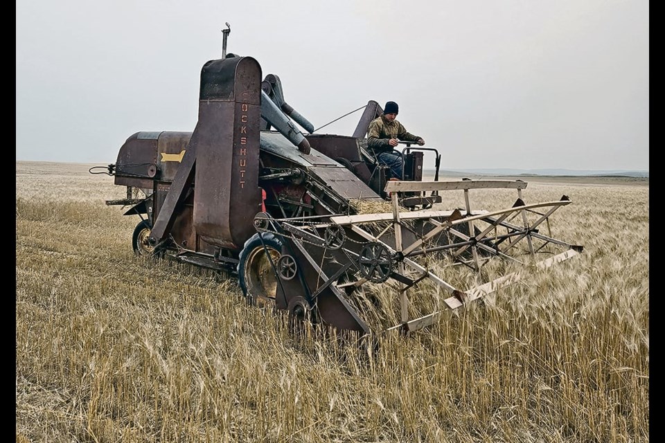 Rhett Ylioja tests out a restored 1947 Cockshutt combine. | 