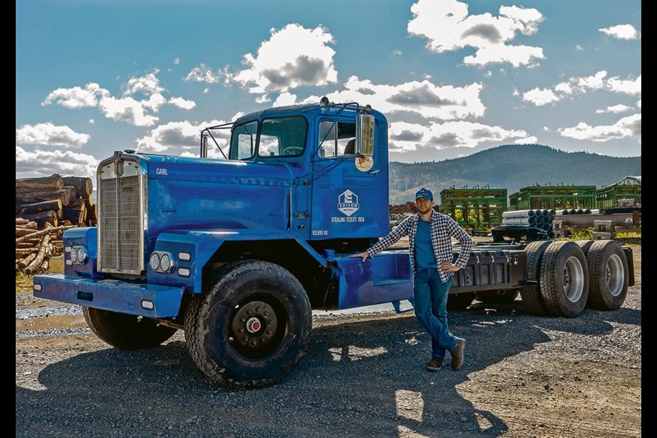 Chace Barber, CEO of Edison Motors, stands beside the company’s first concept truck, a 1962 LW900 Kenworth converted to diesel-electric hybrid drive. 