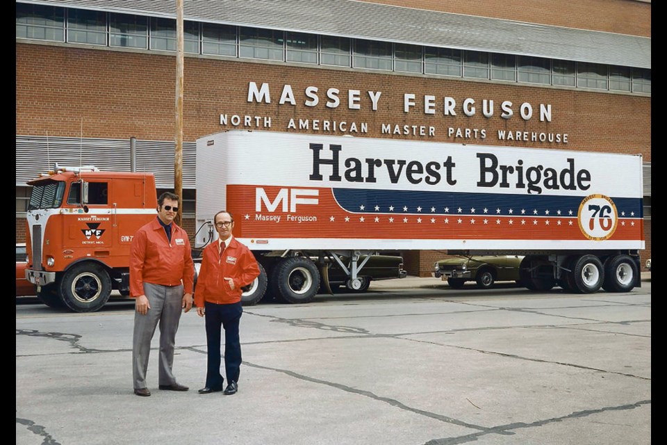 Kerry English, left, and another MF employee pose with the Harvest Brigade parts truck. 