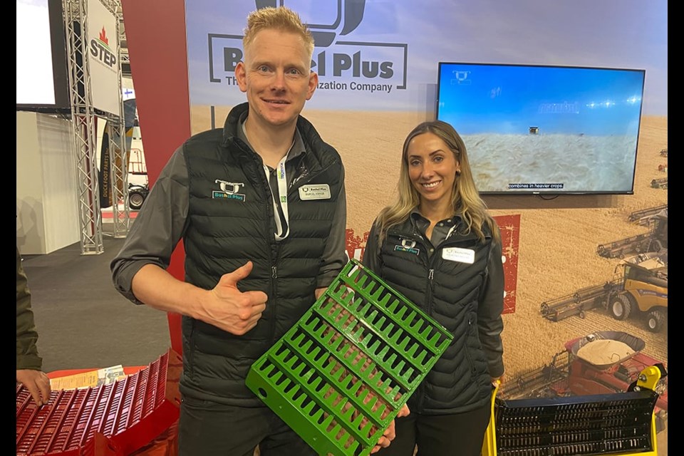 Marcel Kringe, founder and CEO and Courtney Baxter, global marketing manager, with Bushel Plus show one of the combine concaves they are marketing at Agritechnica. 
