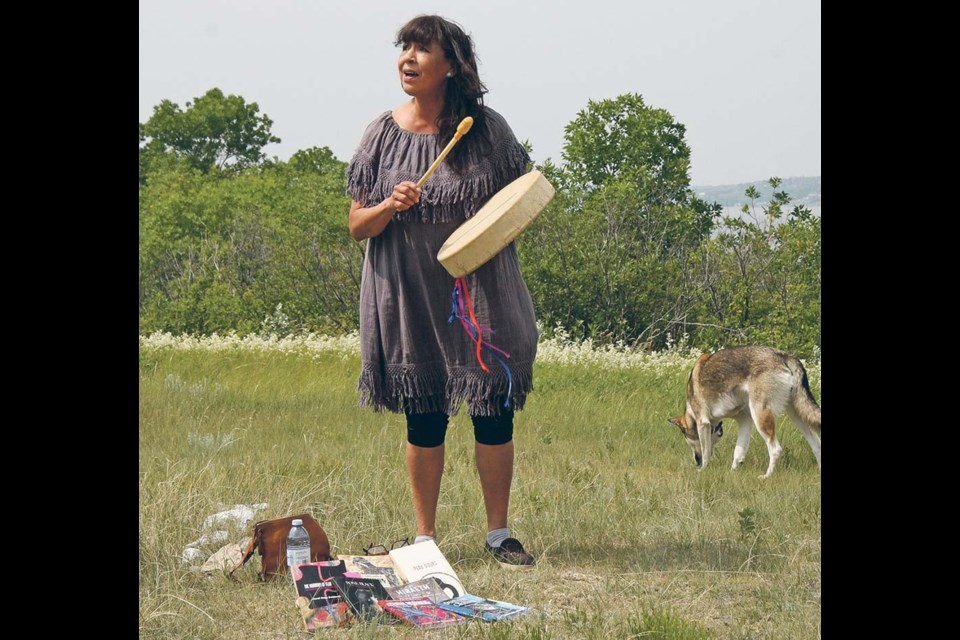 Carol Rose GoldenEagle, Saskatchewan’s poet laureate, drums and sings at a gathering of Treaty Land Sharing Network members. 