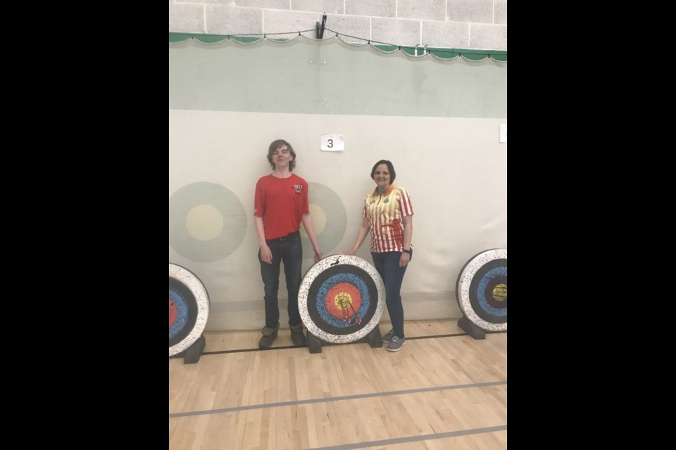 Organizer of the tournament, Angela Murphy, poses next to UCHS student Sebastian Lauinger.