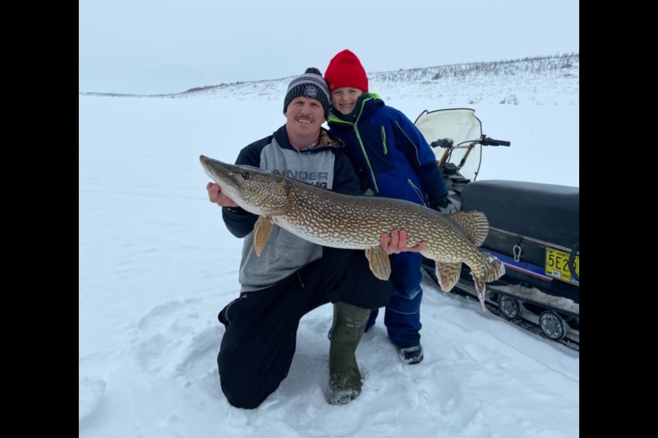 Bradey Fidierchuk and his son Beau with a 47-inch pike. 

