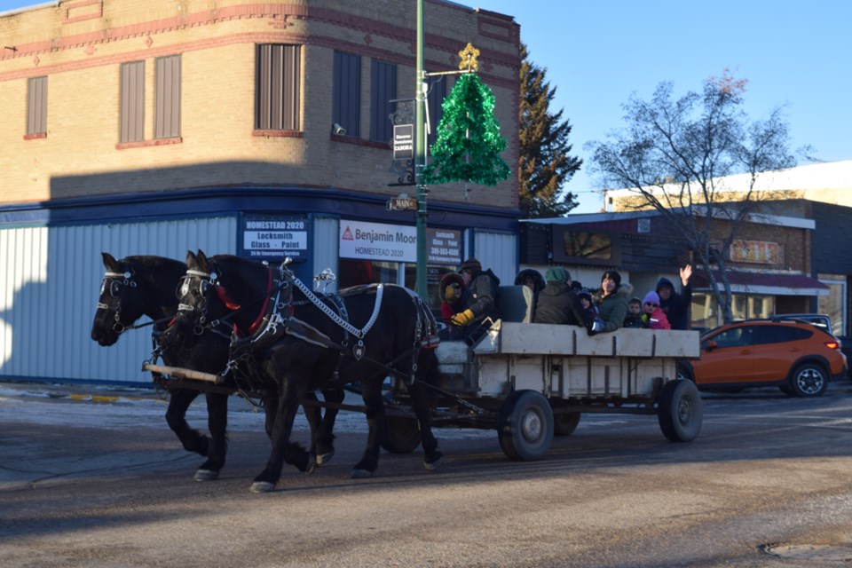 On the first day of the Canora Winter Lights Festival on Nov. 27, one of the highlights was the wagon rides provided by Lloyd Smith of Pelly, with the help of his granddaughter Morgan Wallington. Local residents, young and old alike, took the opportunity to enjoy the ride through downtown Canora in near-ideal weather conditions. Providing the pulling power were Tom, left, and Jiggs, a pair of black Percheron horses. The event was hosted by the Canora Tourism Committee, with Crossroads Credit Union providing hot chocolate and cookies.