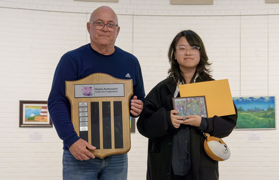 Shiro Luong, winner of this year’s Hazee award for $500, with her trophy beside Rob Rongve, co-sponsor of the Hazee Award. Rob and Nora Rongve sponsor the annual Hazee Awards. Rob thanked all the judges, saying there were 80 participants, which made the judging extra hard this year. Last year there were 57 participants.