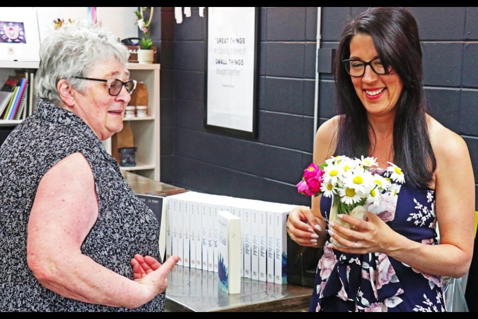 Darlene Martin brought some flowers for her daughter Alison, as Alison was holding a book-signing at the Collabartive Studio on Thursday evening, while visiting here from Haines Junction, Yukon.