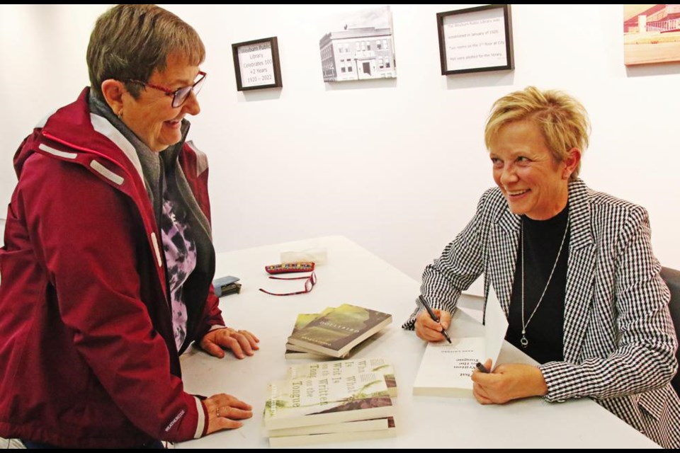 Sherry Klemmer had her copy of the book, What is Written on the Tongue, signed by author Anne Lazurko at an event held at the Weyburn Public Library on Oct. 19.