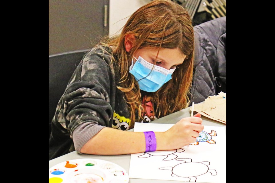 Jayla Duddy concentrated on painting her sea turtle picture during "Art in Session", held on Nov. 17.