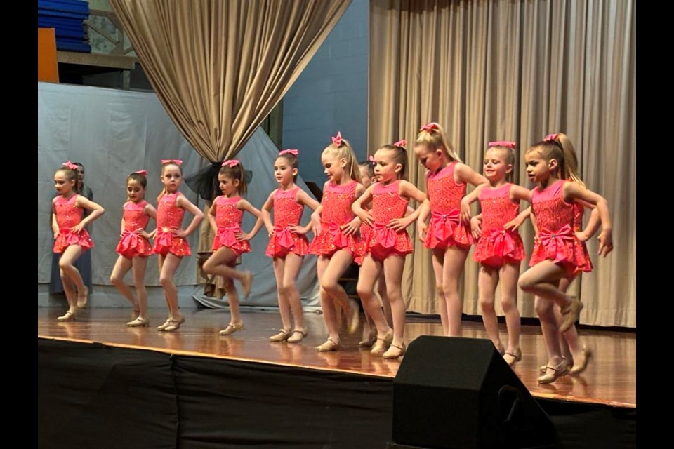 Twelve beginner tap dancers show off their tapping skills to “Better When I’m Dancing”, choreographed by junior teacher Miss Emily Hango.