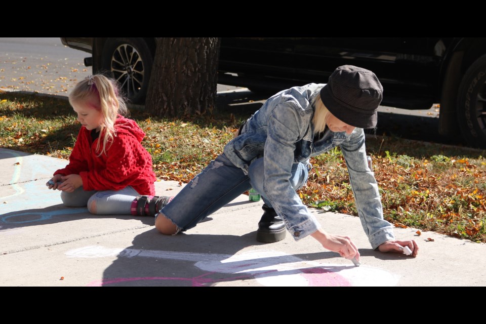 Jadeah Mackenzie, left, and Jennifer Prosko draw with chalk during last year's Culture Days. (File Photo)